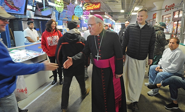 Bishop Richard J. Malone greets Easter shoppers during a visit to the Broadway Market on Saturday morning. (Dan Cappellazzo/Staff Photographer)
